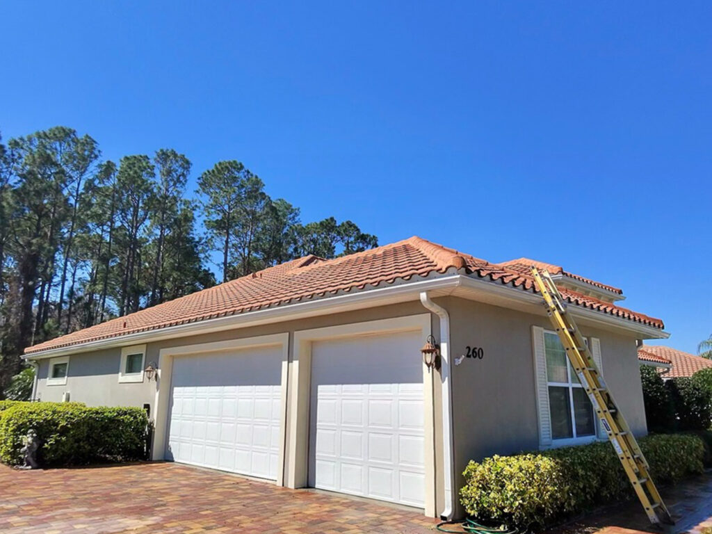Roof being soft washed to remove black streaks